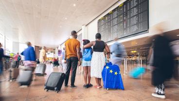 Semesterfirare står vid en flygplats